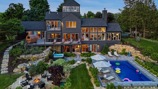 A large, multi-story house with a swimming pool, outdoor seating, and a well-maintained garden. - Tower House | Heated Pool, Sauna, Hot Tub + Views (Galena)