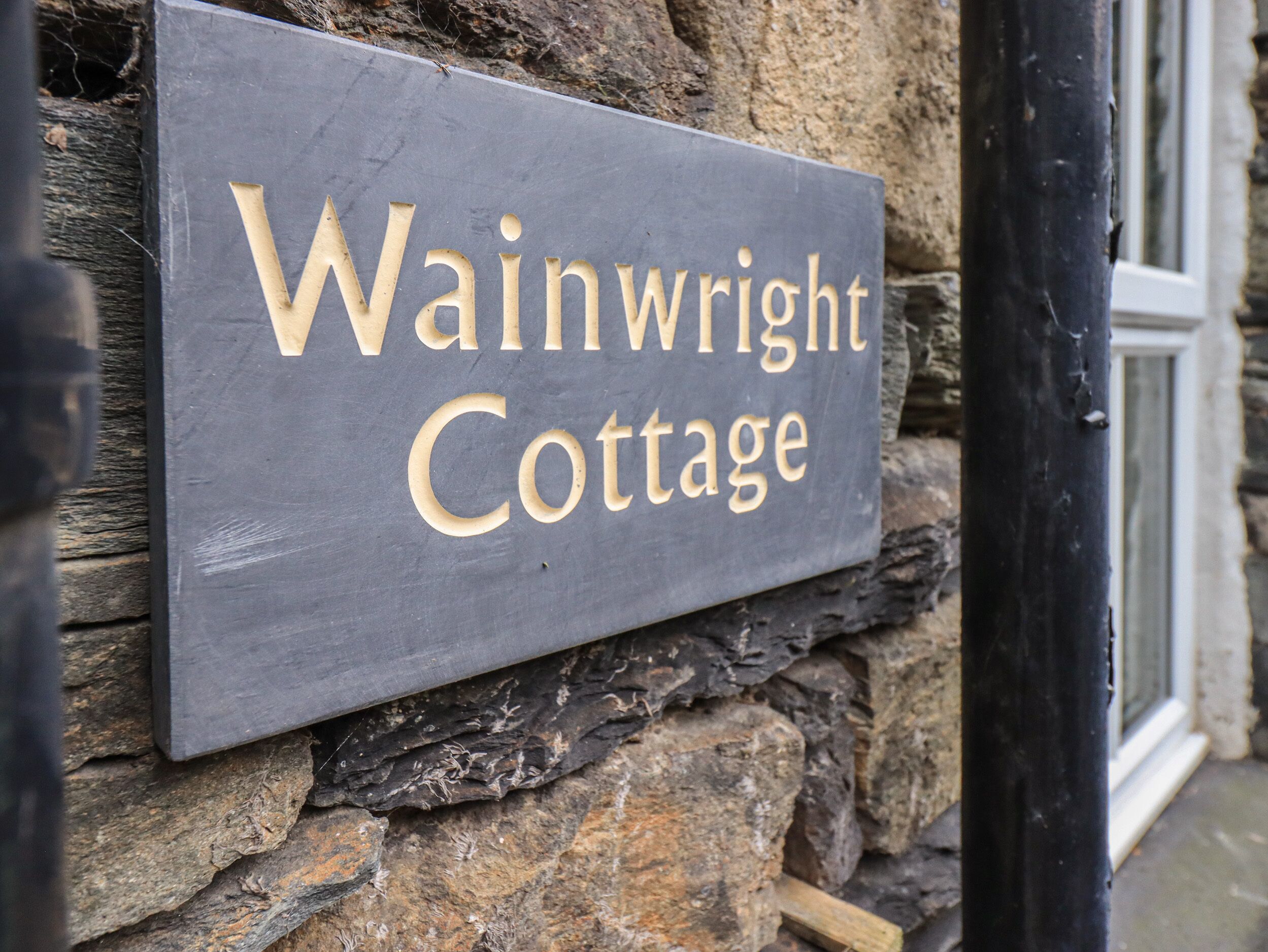 A sign for Wainwright Cottage.