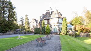 A large stone building with a symmetrical facade, a central entrance, and a conservatory. - Loughrigg Suite (Ambleside)