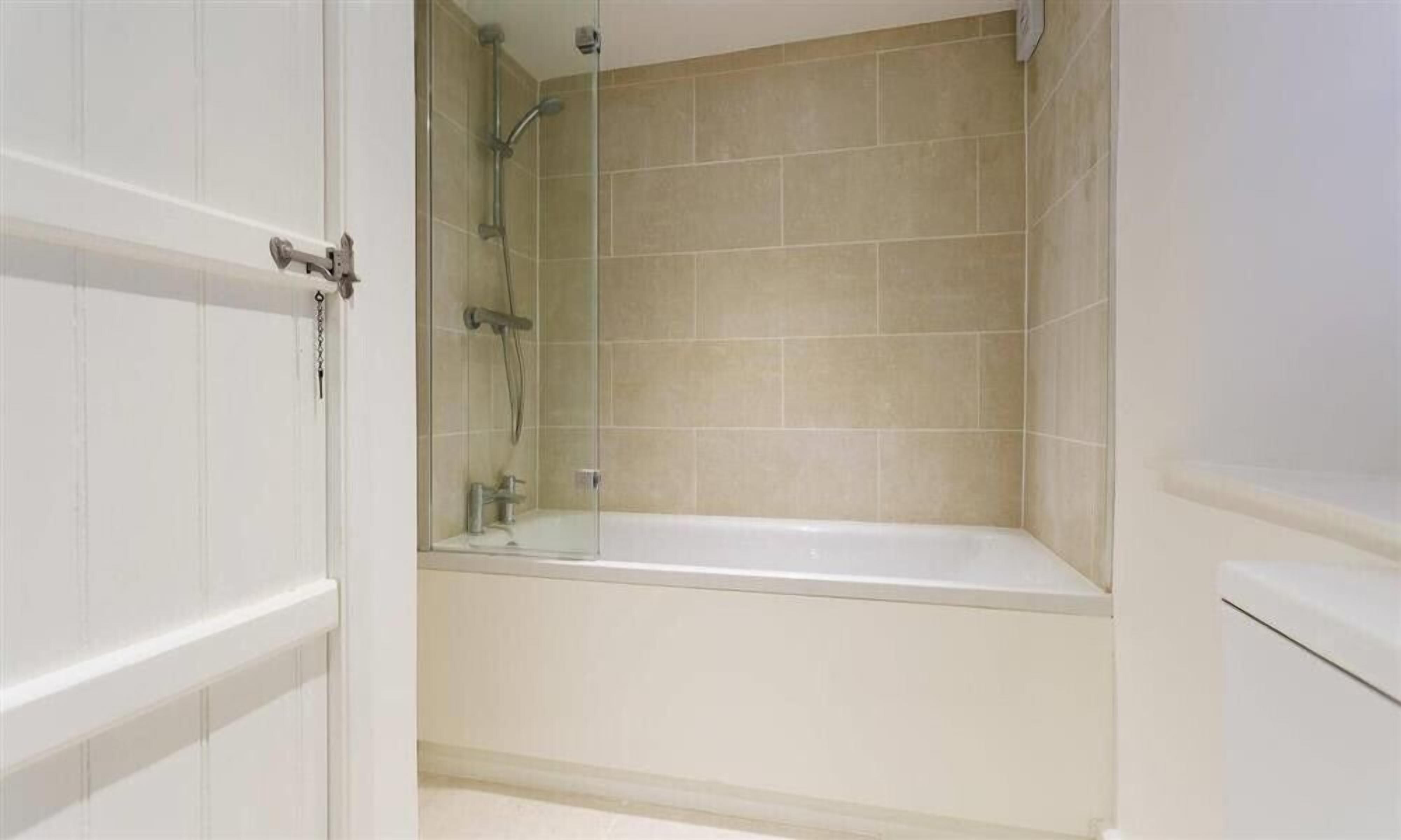 A bathroom with a bathtub, a shower, and a toilet.