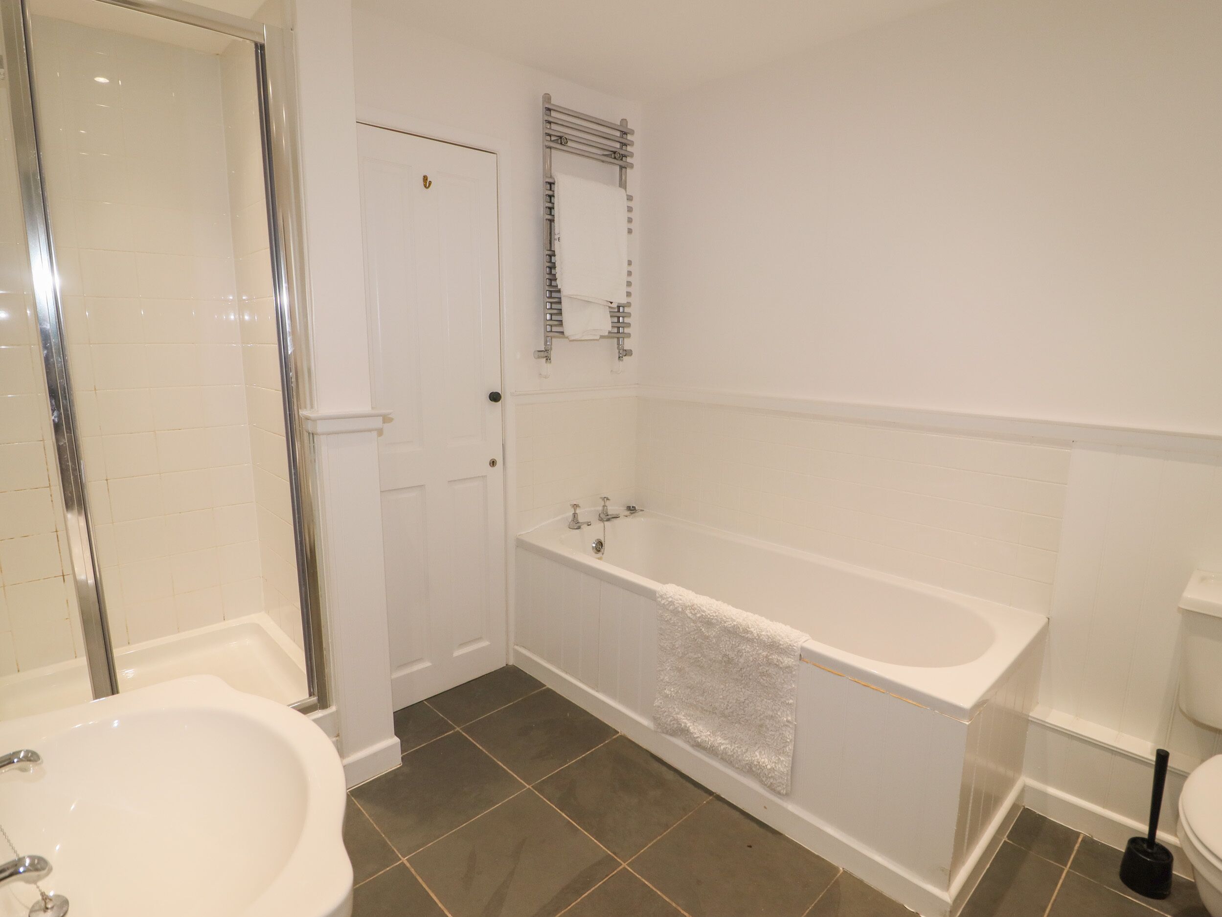 A bathroom with a bathtub, a shower, and a sink.