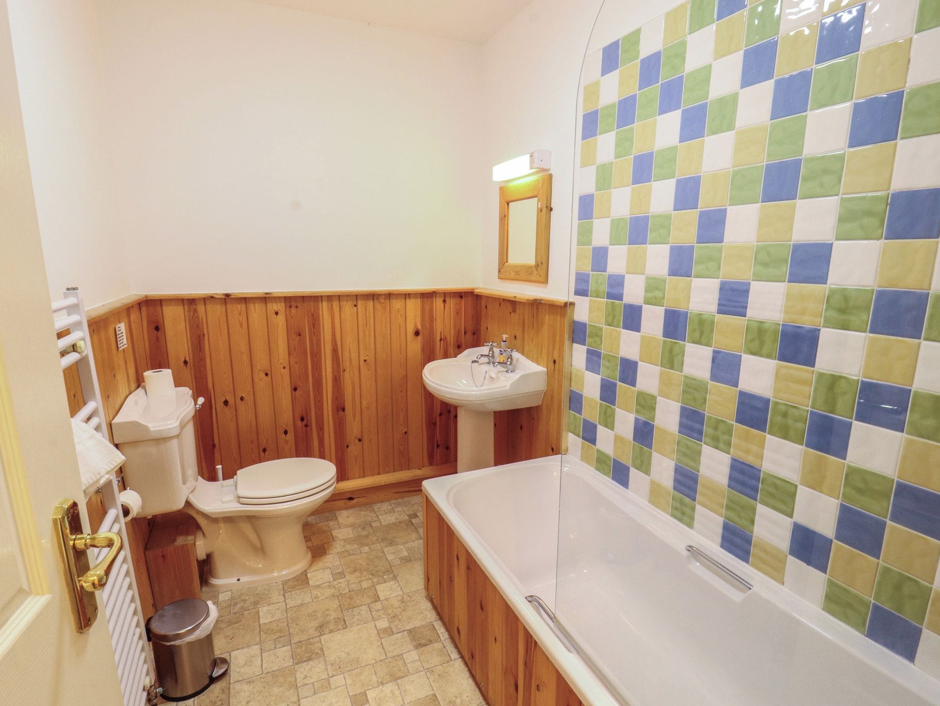 A bathroom with a toilet, sink, and bathtub.