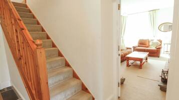 A staircase leading to a living area with a sofa and a coffee table.