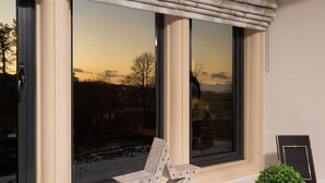 A room with large windows, a view of a snowy landscape, and a chair by the window. - Hygge at No.8 (Windermere)