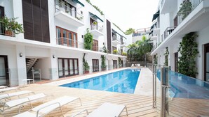 A rooftop pool area with lounge chairs and a clear blue pool. - Beatiful view in front the sea ,inside old City (Cartagena de Indias)
