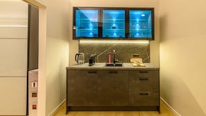 A kitchen with a built-in microwave, a coffee maker, and a kettle on the counter. - Apartment "Gasthof Alte Post - Top 4 Commodore" (Gmünd in Kärnten)