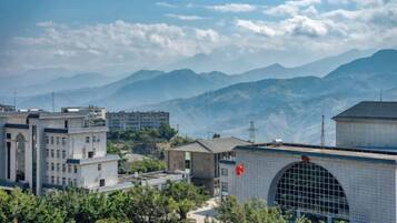 A mountainous landscape with buildings in the foreground.