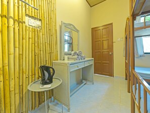 A bathroom with a bamboo wall, a sink with towels, a mirror, and a door. - Capital O 90665 Countryview Recreation Park & Resort (Kuala Lipis)
