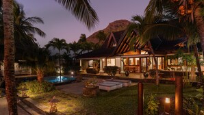 A resort with a pool, outdoor seating, and tropical landscaping. - Villa Matahari by muse villas (Black River)