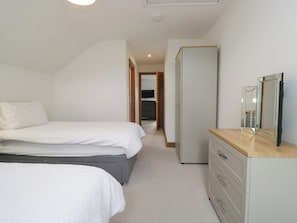 A bedroom with a bed, a dresser, and a wardrobe. - Sherriff (Penrith)