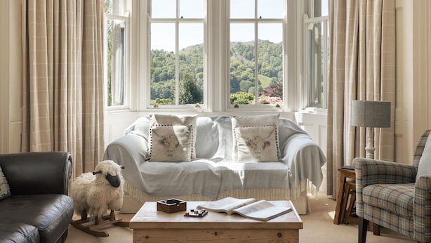 A cozy living room with a sofa, a coffee table, and a lamp. - Wetherlam (Ambleside)