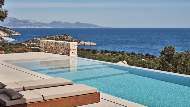 A pool with lounge chairs and a stone wall, overlooking a coastal landscape with mountains and the sea. - The Sall Villa - 2 Bedrooms with Private Pool & Sea View (Volimes)