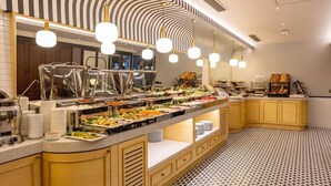 A buffet setup with various food stations, a patterned floor, and a modern ceiling design. - Eyfel Hotel (Istanbul)