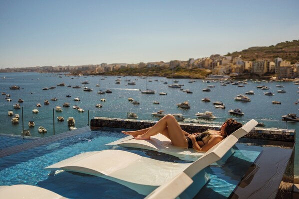 Indoor pool, seasonal outdoor pool, pool umbrellas, pool loungers