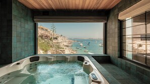 A hot tub with a view of boats on the water, a wooden ceiling, and tiled walls. - Damare Resort & Spa (St. Paul's Bay)