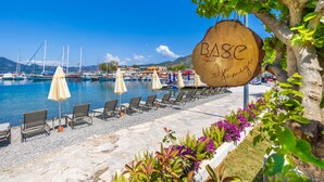 A waterfront hotel with a wooden sign reading "BASE" and "El Bierzo". - BASE Selimiye (Marmaris)