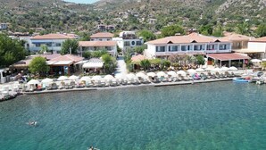 A coastal town with a marina, clear waters, and buildings with red-tiled roofs. - BASE Selimiye (Marmaris)
