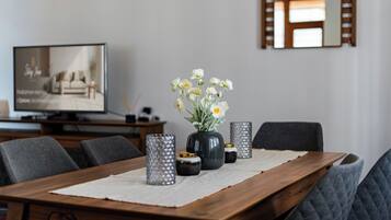 Superior appartement | Woonruimte | Een 55-inch flatscreentelevisie met kabelzenders