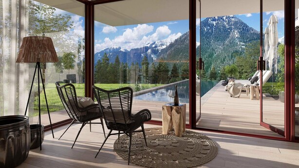 A modern room with a large glass door leading to a balcony with a mountain view.