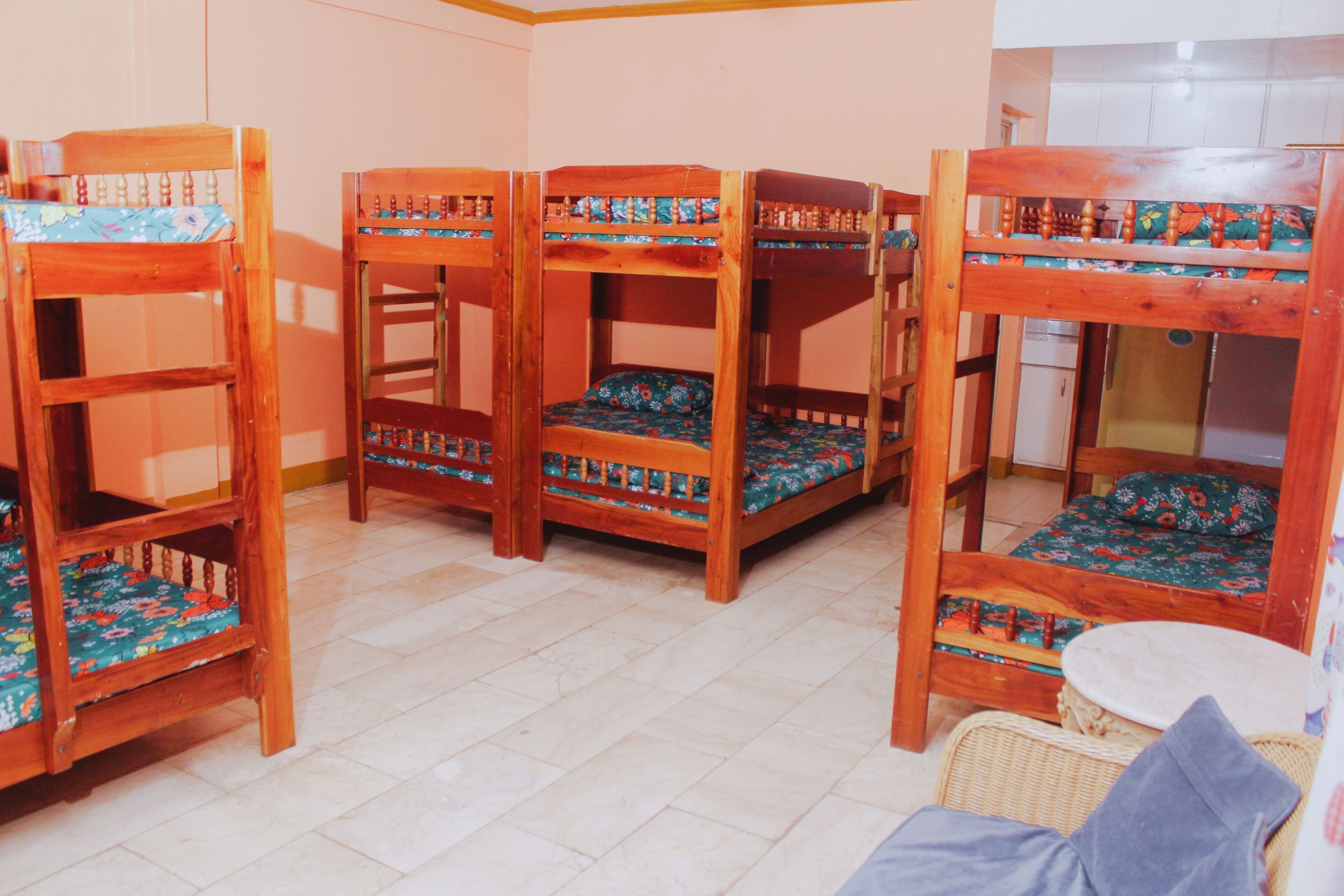 A room with bunk beds and a small table.