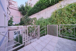 Stunning residential building with a modern design, surrounded by lush greenery and a staircase leading to an upper level.