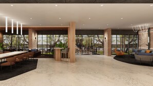 A spacious indoor area with a long table, multiple chairs, and a seating area with sofas and a coffee table. - Citadines Connect Georgetown Penang (George Town)