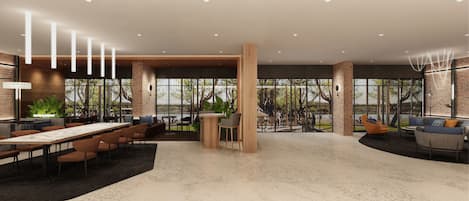 Un grand espace intérieur comprenant une longue table, plusieurs chaises et un coin salon avec des canapés et une table basse.