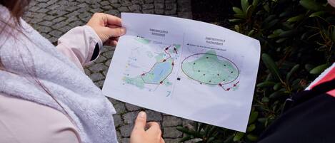A person holding a map with marked jogging routes.