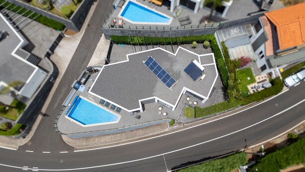 A top-down view of a property with a swimming pool, solar panels, and a landscaped area. - Villa Stella by LovelyStay (Arco Da Calheta)