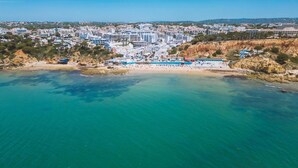 An aerial view of a coastal town with a beach and buildings. - Fisherman's cottage a few steps from the beach (Olhos de Água)