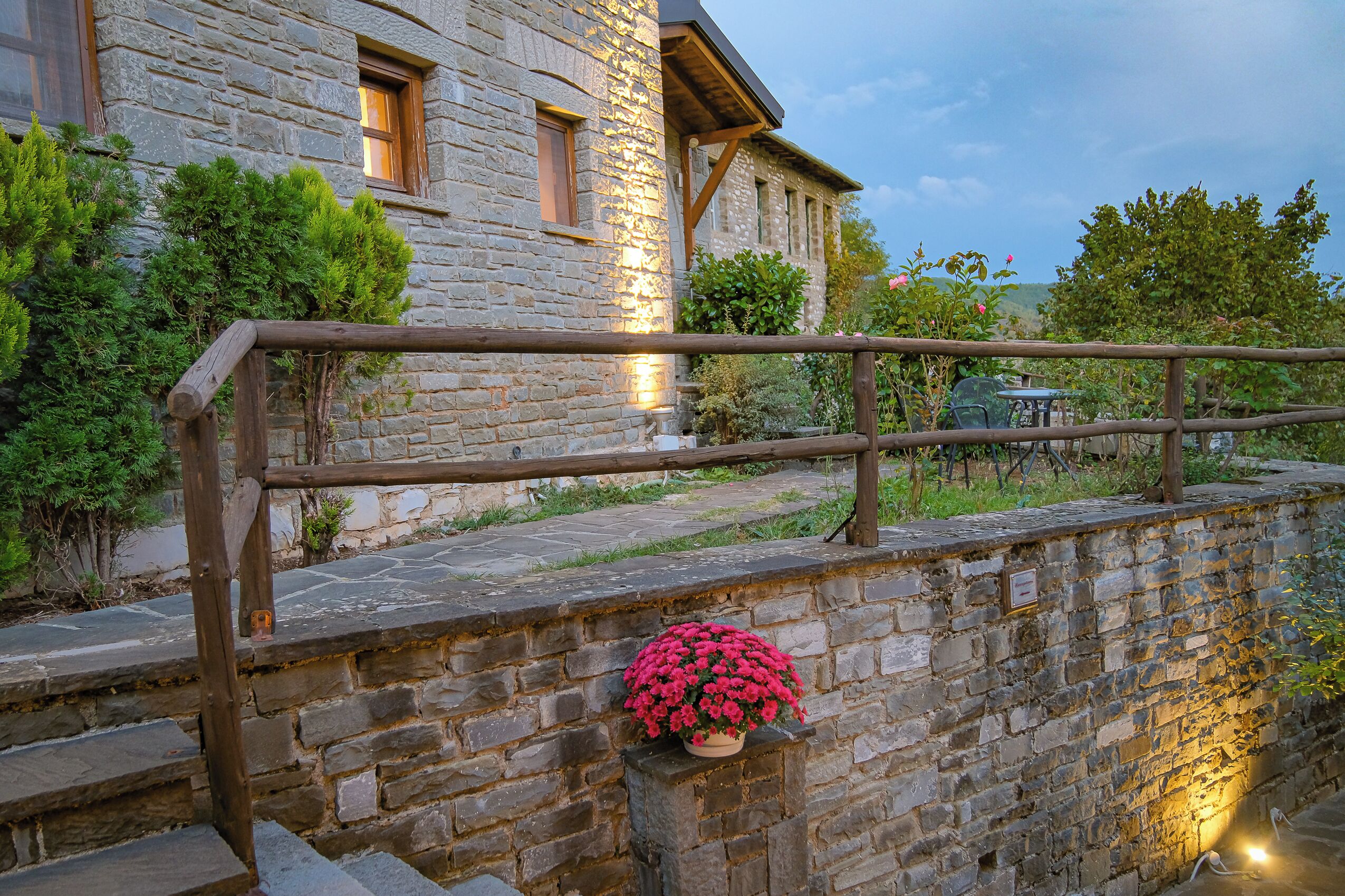 A stone building with a wooden railing and steps leading up to it.