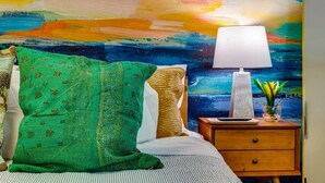 A room with a bed, a nightstand, a lamp, and a colorful abstract painting on the wall. - Cozy Denver Stay | Grill + Patio | Sloan’s Lake| Firepit (Denver)