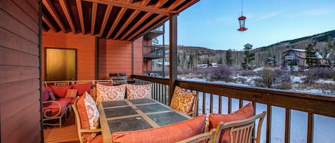 Relax on the deck with a view of the surrounding landscape and distant buildings.