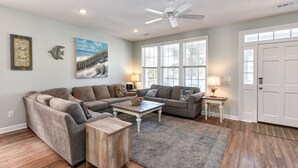 A living room with a sectional sofa, a coffee table, and a rug. - 2nd Row, 4 BR Beach House with Community Pool! Endless Summer Nights (Surfside Beach)