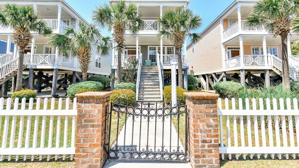 A row of beachfront houses with balconies, a gated entrance, and palm trees. - 2nd Row, 4 BR Beach House with Community Pool! Endless Summer Nights (Surfside Beach)