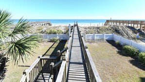 A wooden boardwalk leading to a beach with a clear view of the ocean. - Oceanfront 7 BR Beach House with a Private Pool! Royal Palm (Garden City)