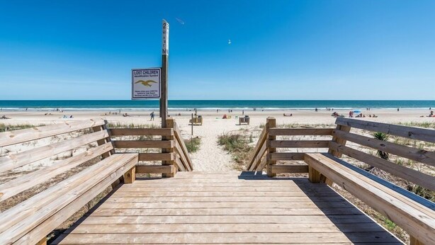 A wooden boardwalk leading to a beach with a sign warning of lost children. - Ocean View 7 BR Beach House with a Private Pool! Seaside Retreat  (Surfside Beach)
