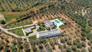 An aerial view of a property with a swimming pool, a large building, and surrounding vegetation. - 2283 Villa La Paiara by Perle di Puglia (Melendugno)