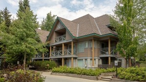Un bâtiment à deux étages, doté d’un toit à pignon, d’une façade en bois et d’un balcon au deuxième étage.