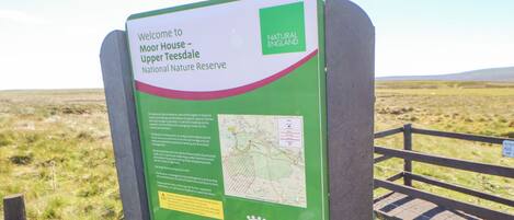 A sign welcoming visitors to Moor House Upper Teesdale National Nature Reserve.