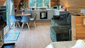 A cozy cabin interior with a kitchen, dining area, and living space. - Lakeview Lodge- UK40692 (Crowhurst)