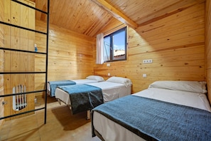 A wooden cabin with three beds, a window with a curtain, and a metal ladder. - Holiday Home "Faro" with Pool, Garden & Wi-Fi (Camarles)