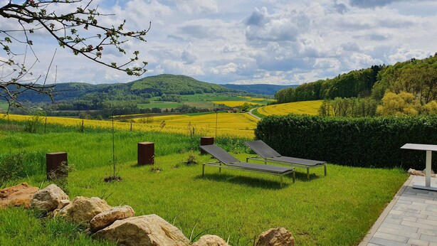 A grassy outdoor area with two sun loungers, a metal bench, and a metal table. - "Little time out" - fantastic view of the Franconian countryside - ideal for bikers. (Scheßlitz)