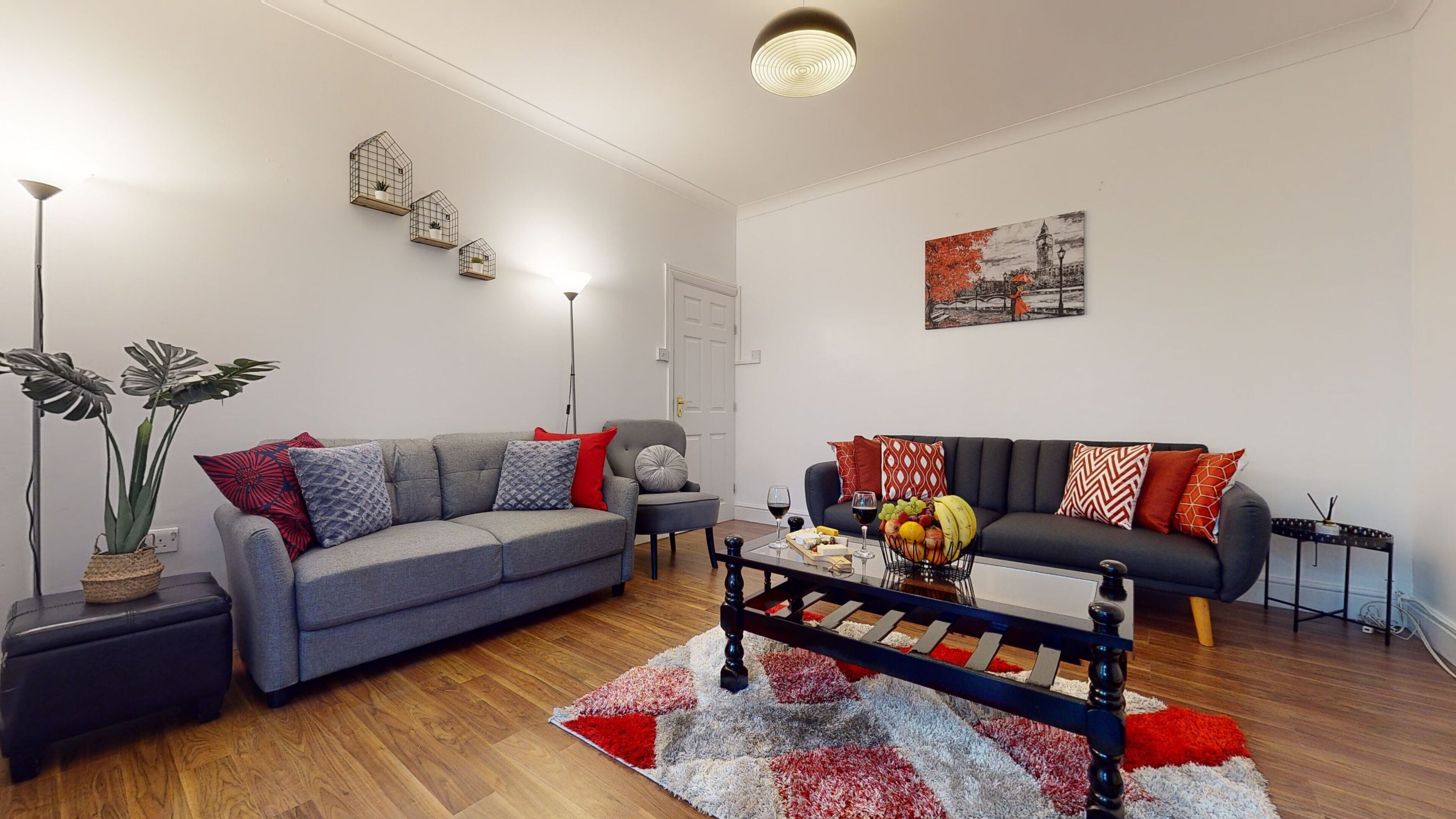 A modern living room with two sofas, a coffee table, and a floor lamp.