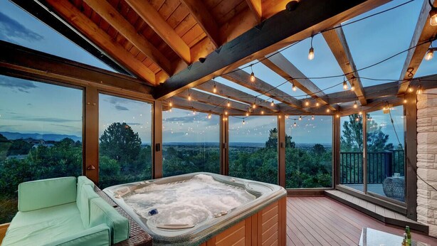 A hot tub in a wooden deck with a view of the landscape. - Broadmoor Luxury Retreat - Mountain View & Hot Tub (Colorado Springs)