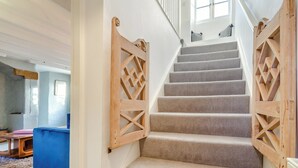 A staircase with wooden railings and carpeted steps leading to a second floor. - 3 bedroom accommodation in Kettleness, near Whitby (Kettleness, near Whitby)