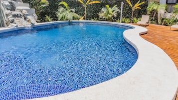 Outdoor pool, open 8:00 AM to 8:00 PM, pool loungers