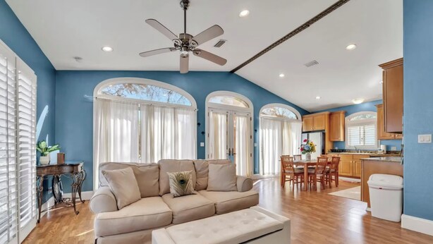 A living room with a sofa, ottoman, and a ceiling fan. - Eden Guest House on Bayfront Mansion Estate. A 3/3! 20 scenic minutes to Destin (Freeport)