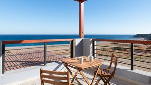 A wooden table with two chairs and a small table on a balcony overlooking the ocean. - Southrock Villas - 6 Bed Executive Seaview Villa with Private Pool (New Listing) (Lachania)