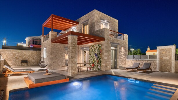 A modern house with a swimming pool, stone walls, and a wooden pergola. - Southrock Villas - 6 Bed Executive Seaview Villa with Private Pool (New Listing) (Lachania)